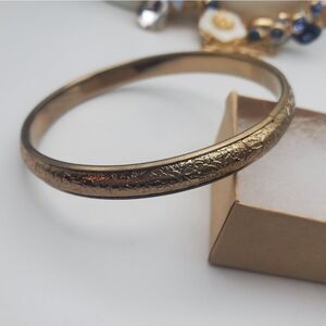 Gold toned intricate carved bracelet bangle regency